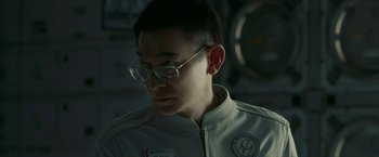 Movie still from “The Wandering Earth II” (2023), directed by Frant Gwo – A man wearing glasses and a white jacket; Close Up shot, Over the shoulder angle