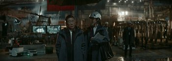 Movie still from “The Wandering Earth II” (2023), directed by Frant Gwo – A man and a woman standing under an umbrella in the rain; Medium shot, Over the shoulder angle