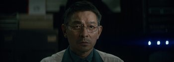Movie still from “The Wandering Earth II” (2023), directed by Frant Gwo – An older man wearing glasses and wearing a shirt; Close Up shot, Low angle