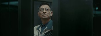 Movie still from “The Wandering Earth II” (2023), directed by Frant Gwo – A man wearing glasses looking at a mirror; Close Up shot, Low angle