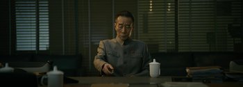Movie still from “The Wandering Earth II” (2023), directed by Frant Gwo – An older man sitting at a table with a cup of coffee; Medium shot, Low angle