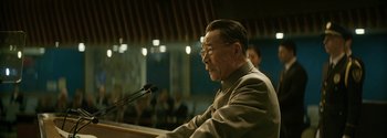Movie still from “The Wandering Earth II” (2023), directed by Frant Gwo – An older man is speaking at a microphone; Medium shot, Low angle
