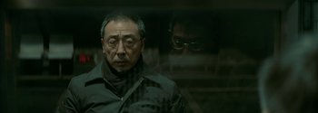 Movie still from “The Wandering Earth II” (2023), directed by Frant Gwo – An older asian man looking out of a window; Close Up shot, Low angle