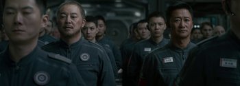 Movie still from “The Wandering Earth II” (2023), directed by Frant Gwo – A group of men in uniform standing next to each other; Medium shot, Over the shoulder angle