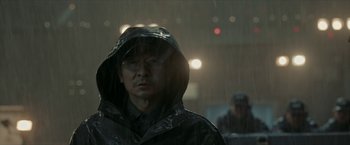 Movie still from “The Wandering Earth II” (2023), directed by Frant Gwo – A man wearing a raincoat in the rain; Close Up shot, Over the shoulder angle