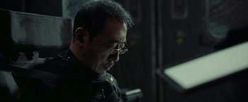 Movie still from “The Wandering Earth II” (2023), directed by Frant Gwo – An older man wearing glasses and a black jacket; Close Up shot, Over the shoulder angle