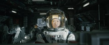 Movie still from “The Wandering Earth II” (2023), directed by Frant Gwo – A man in a spacesuit and helmet in a room; Medium shot, Low angle