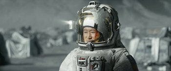 Movie still from “The Wandering Earth II” (2023), directed by Frant Gwo – A man in a spacesuit and helmet on the moon; Close Up shot, Low angle