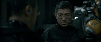Movie still from “The Wandering Earth II” (2023), directed by Frant Gwo – A man wearing a black jacket and glasses; Close Up shot, Over the shoulder angle