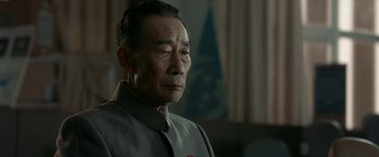 Movie still from “The Wandering Earth II” (2023), directed by Frant Gwo – An older man wearing a gray shirt and a red tie; Close Up shot, Low angle