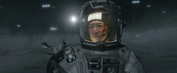 Movie still from “The Wandering Earth II” (2023), directed by Frant Gwo – A man in a spacesuit and a helmet; Close Up shot, Over the shoulder angle