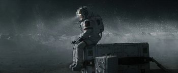 Movie still from “The Wandering Earth II” (2023), directed by Frant Gwo – An astronaut sitting on top of a suitcase; Wide shot, Overhead angle