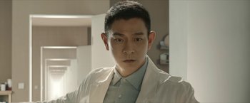 Movie still from “The Wandering Earth II” (2023), directed by Frant Gwo – A man wearing a white lab coat in a room; Close Up shot, Low angle