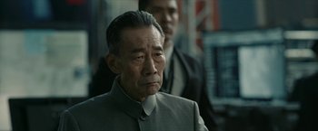 Movie still from “The Wandering Earth II” (2023), directed by Frant Gwo – An older man wearing a suit and tie; Close Up shot, Over the shoulder angle