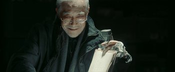 Movie still from “The Wandering Earth II” (2023), directed by Frant Gwo – An older man holding a pen and paper; Close Up shot, Low angle