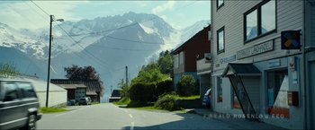 Movie still from “The Wave” (2015), directed by Roar Uthaug – A view of a street with a mountain in the background; Extreme Wide shot, Low angle
