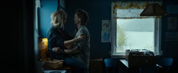 Movie still from “The Wave” (2015), directed by Roar Uthaug – A man and a woman are hugging in a room; Medium shot, Low angle