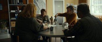 Movie still from “The Wave” (2015), directed by Roar Uthaug – A group of people sitting at a table with food; Wide shot, High angle
