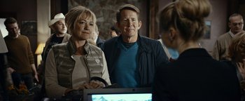 Movie still from “The Wave” (2015), directed by Roar Uthaug – A man and a woman standing in front of a computer; Medium shot, Over the shoulder angle