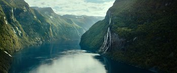 Movie still from “The Wave” (2015), directed by Roar Uthaug – A body of water surrounded by mountains and a cliff; Extreme Wide shot, High angle
