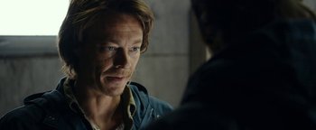Movie still from “The Wave” (2015), directed by Roar Uthaug – A man in a blue jacket is looking at a man in a blue jacket; Close Up shot, Over the shoulder angle