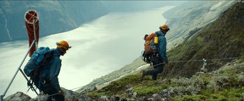 Movie still from “The Wave” (2015), directed by Roar Uthaug – A man and a dog on a mountain side; Extreme Wide shot, Low angle