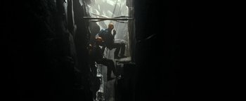 Movie still from “The Wave” (2015), directed by Roar Uthaug – A group of people hanging from ropes in a cave; Extreme Wide shot, High angle