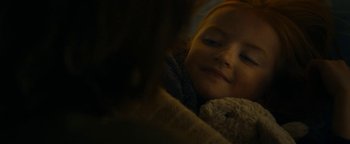 Movie still from “The Wave” (2015), directed by Roar Uthaug – A little girl laying on top of a bed next to a teddy bear; Close Up shot, Over the shoulder angle
