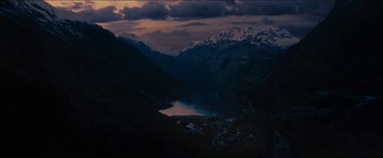 Movie still from “The Wave” (2015), directed by Roar Uthaug – A view of a lake and mountains at night; Extreme Wide shot, High angle