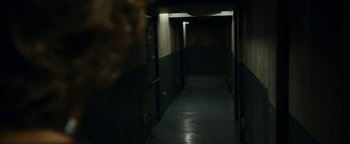 Movie still from “The Wave” (2015), directed by Roar Uthaug – A dark hallway with lights on the ceiling; Wide shot, Low angle