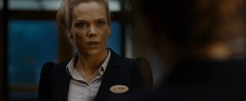 Movie still from “The Wave” (2015), directed by Roar Uthaug – A woman in a black jacket with a name tag; Close Up shot, Over the shoulder angle