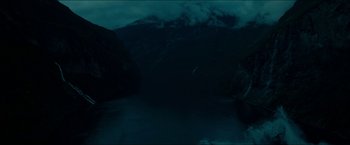 Movie still from “The Wave” (2015), directed by Roar Uthaug – A bird flying over a body of water at night; Extreme Wide shot, High angle