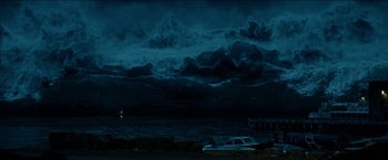 Movie still from “The Wave” (2015), directed by Roar Uthaug – A car is parked in front of a body of water at night; Extreme Wide shot, Over the shoulder angle
