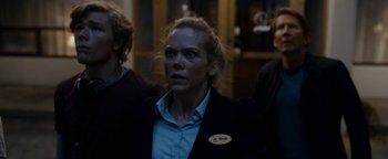 Movie still from “The Wave” (2015), directed by Roar Uthaug – A woman in a black jacket and a blue shirt; Medium shot, Over the shoulder angle