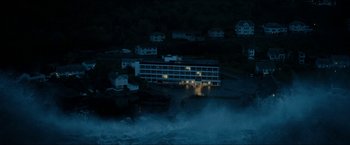 Movie still from “The Wave” (2015), directed by Roar Uthaug – An aerial view of a building in the middle of the night; Extreme Wide shot, High angle