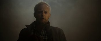 Movie still from “The Wave” (2015), directed by Roar Uthaug – A man with a beard is standing in the fog; Close Up shot, Low angle