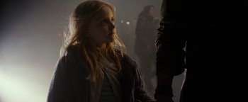 Movie still from “The Wave” (2015), directed by Roar Uthaug – A young girl is standing in a dark room; Close Up shot, Over the shoulder angle