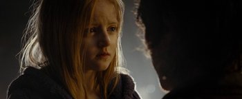 Movie still from “The Wave” (2015), directed by Roar Uthaug – A young girl looking at a young man in a dark room; Close Up shot, Over the shoulder angle