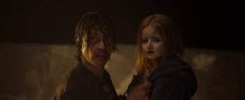 Movie still from “The Wave” (2015), directed by Roar Uthaug – A man and a girl standing next to each other in the dark; Close Up shot, Low angle