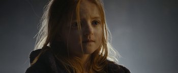 Movie still from “The Wave” (2015), directed by Roar Uthaug – A young girl with red hair is looking at the camera; Close Up shot, Low angle