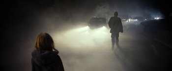 Movie still from “The Wave” (2015), directed by Roar Uthaug – A man and a woman are standing in the fog; Wide shot, Over the shoulder angle