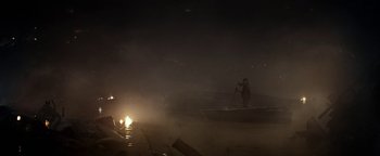 Movie still from “The Wave” (2015), directed by Roar Uthaug – A person in a boat on a body of water at night; Extreme Wide shot, High angle