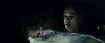Movie still from “The Wave” (2015), directed by Roar Uthaug – A woman sitting in a pool of water at night; Close Up shot, Over the shoulder angle