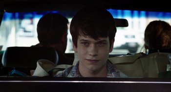 Movie still from “The Way Way Back” (2013), directed by Jim Rash – A young man sitting in the back seat of a car; Close Up shot, Over the shoulder angle