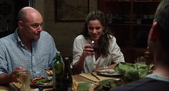 Movie still from “The Way Way Back” (2013), directed by Jim Rash – A group of people sitting around a table with food; Medium shot, Over the shoulder angle