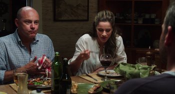 Movie still from “The Way Way Back” (2013), directed by Jim Rash – A woman sitting at a table with a glass of red wine; Medium shot, Over the shoulder angle