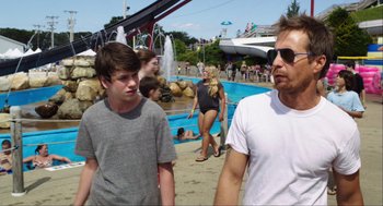 Movie still from “The Way Way Back” (2013), directed by Jim Rash – A man and a boy walking on the beach; Medium shot, Over the shoulder angle