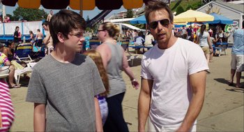Movie still from “The Way Way Back” (2013), directed by Jim Rash – A man and a young boy standing next to each other; Medium shot, Over the shoulder angle
