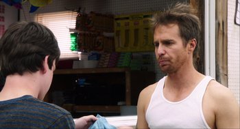 Movie still from “The Way Way Back” (2013), directed by Jim Rash – A man in a white tank top is talking to another man in a white tank top; Close Up shot, Over the shoulder angle