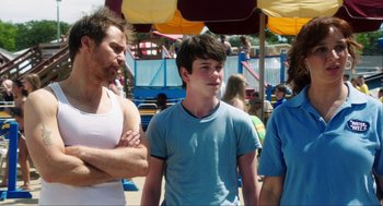 Movie still from “The Way Way Back” (2013), directed by Jim Rash – A group of young men standing next to each other on a beach; Medium shot, Over the shoulder angle